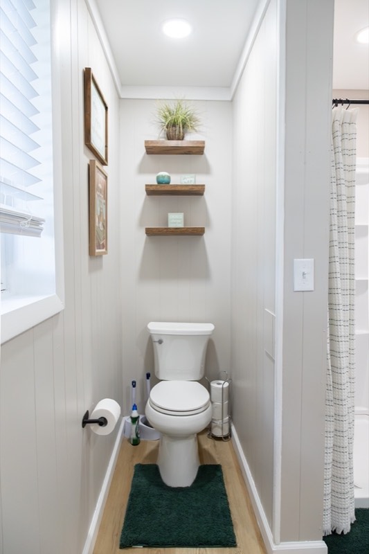 Downstairs bathroom with white paneled walls