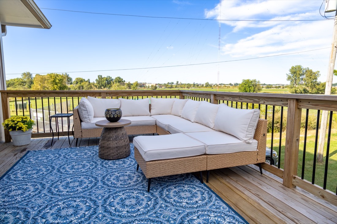 Outdoor sectional on the back deck overlooking the field